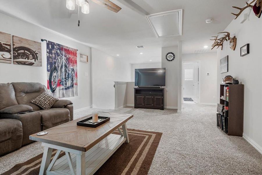 Living room featuring light carpet and ceiling fan