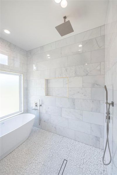 Bathroom with a tile shower and tile floors