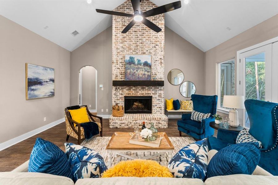 Dramatic cathedral ceiling, brick fireplace and large ceiling fan are great features of this room. Imagine celebrating holidays in this home, be it Thanksgiving or Christmas...just soak up all this beauty.