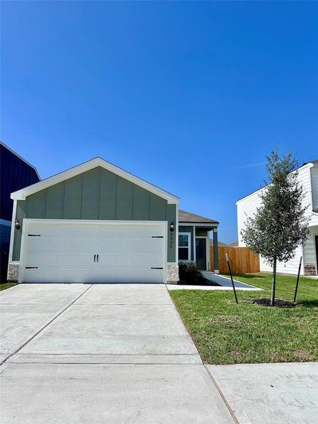 The Pecan is a beautiful, modern home with garage door accents and a nice tree in the front yard to provide shade in the coming years.