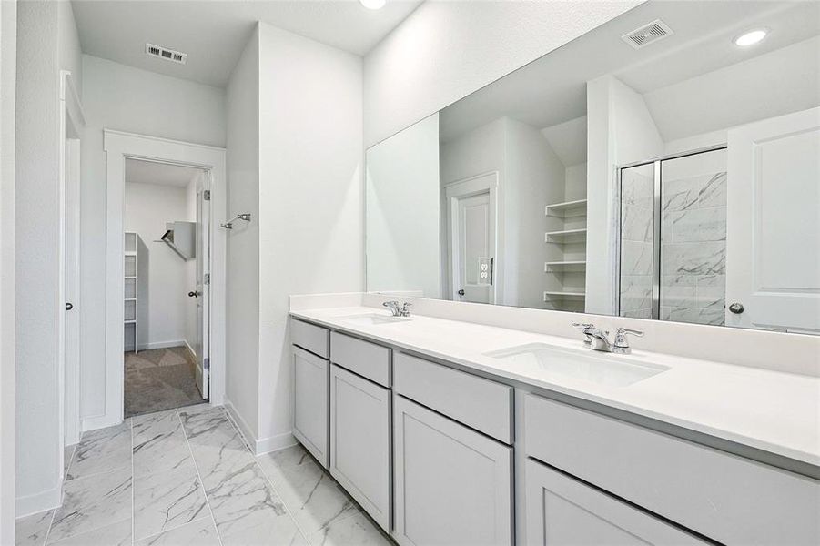 Bathroom with tile patterned floors, vanity, and walk in shower