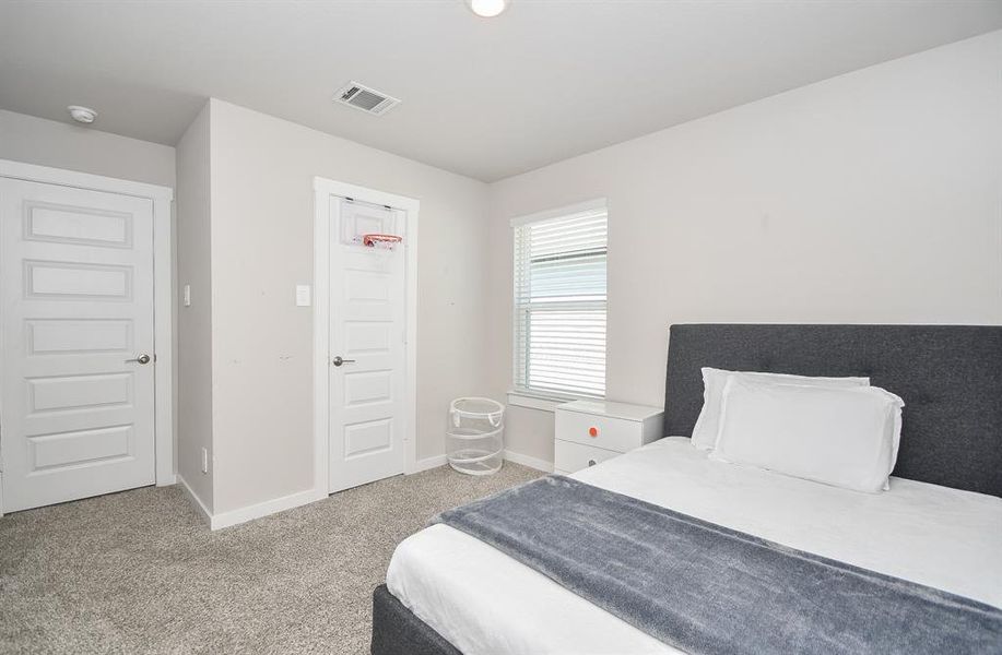 Bedroom with a bed, nightstand, and minimal decor.