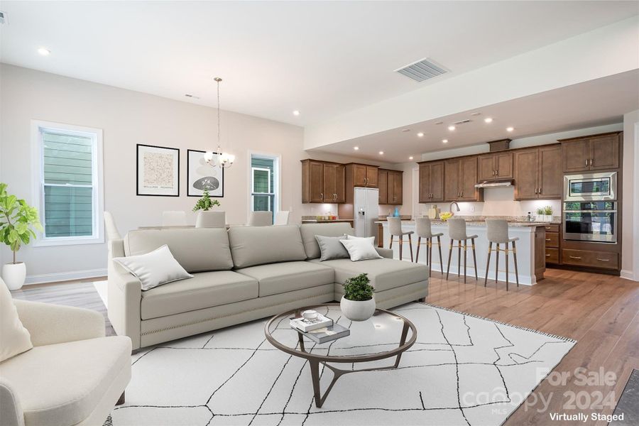 The Laurel's expansive open floorplan beautifully highlights the upgraded LVP low maintenance flooring, creating a seamless flow thru-out he home.