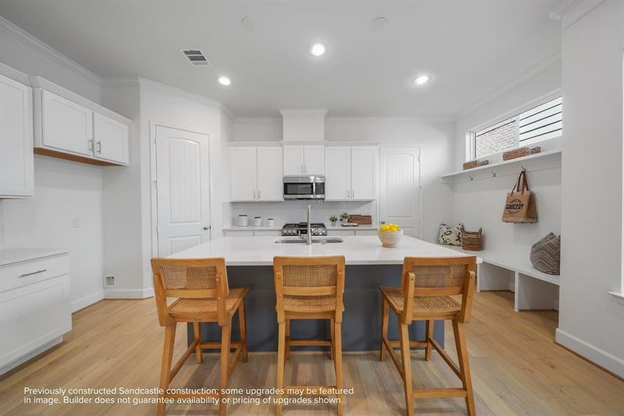 Culinary Excellence: Centered around a generous kitchen island, this modern chef's paradise boasts the latest in sleek stainless steel appliances from LG or Bosch, marrying function with sophistication.