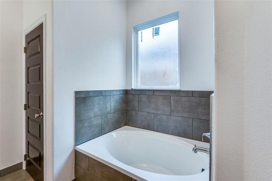 Bathroom featuring tiled bath