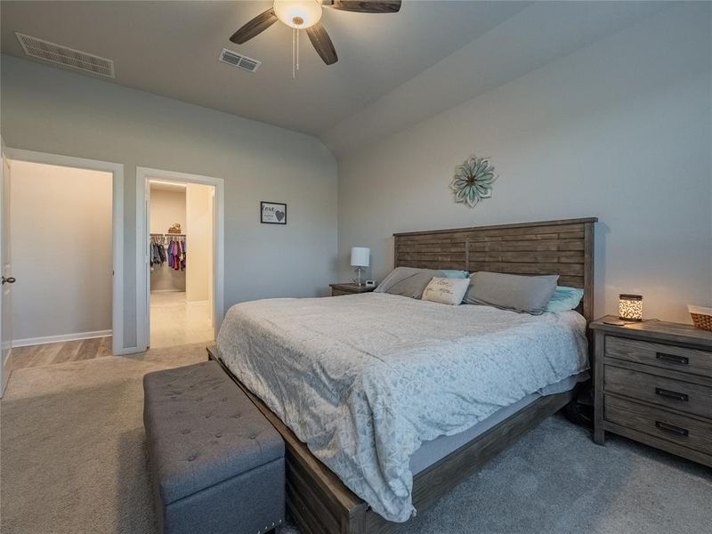 oversized primary bedroom with plush carpet