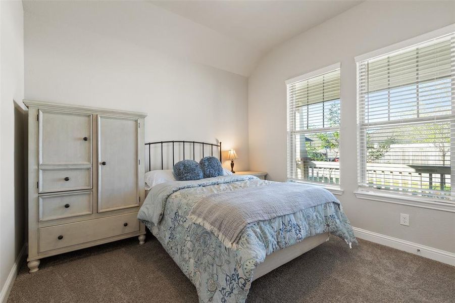 Charming front-facing guest bedroom with natural light and easy access to the home's amenities.