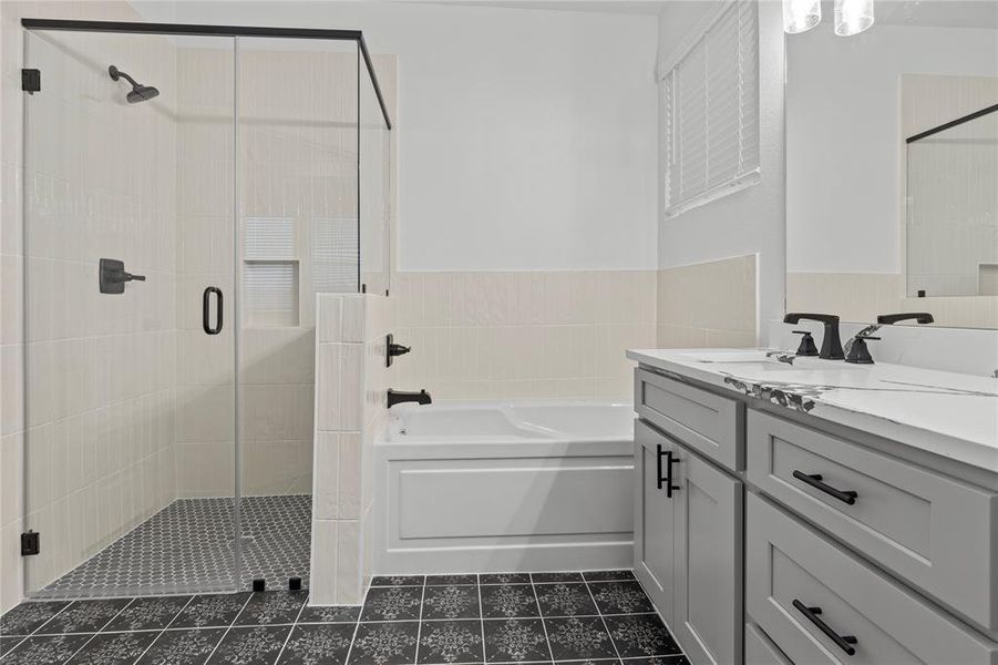 Enjoy framed matte black shower and separate tub.