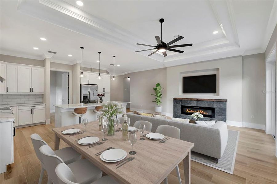 Enjoy the seamless flow of this open-concept home with a modern kitchen, cozy fireplace, and inviting dining area - perfect for entertaining or relaxing.