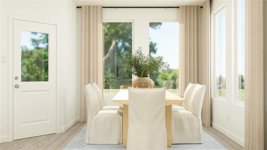 Dining area featuring light hardwood / wood-style floors and a healthy amount of sunlight