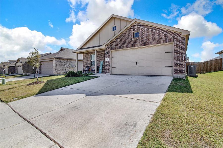 View of front of house featuring a front yard and a garage