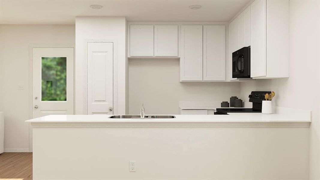 Kitchen with white cabinets, light hardwood / wood-style floors, sink, and kitchen peninsula