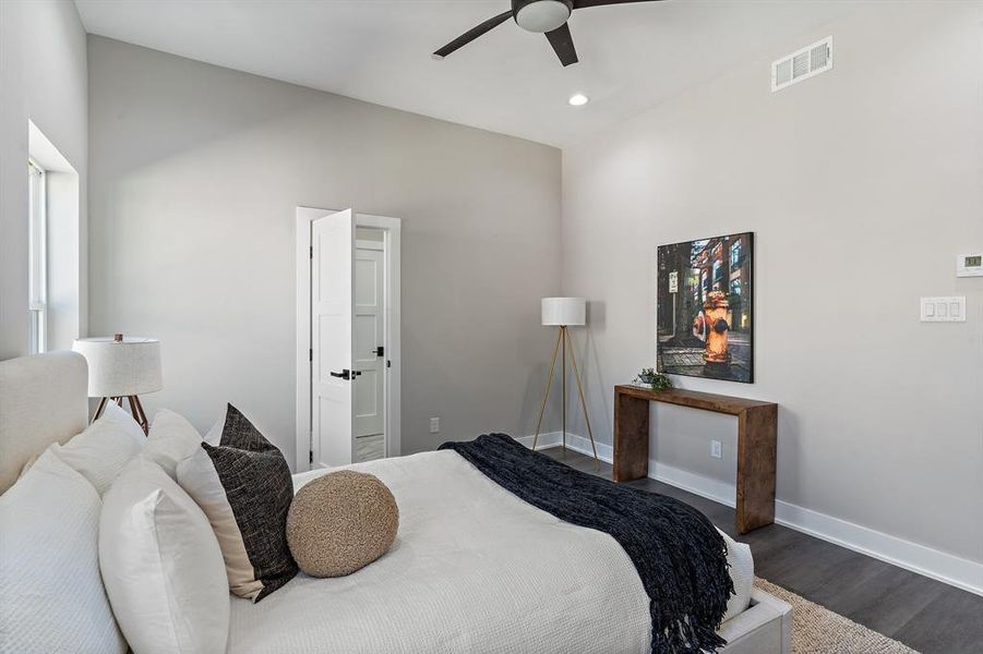 Bedroom featuring ceiling fan and dark wood-type flooring