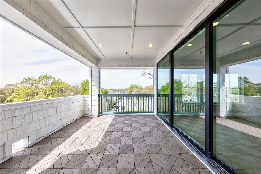 Deep and spacious oversized balcony off living area with 10-ft glass sliding trifold doors.