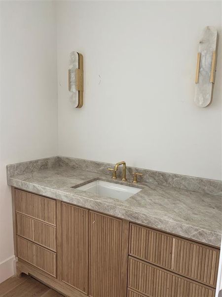 Powder room with reeded vanity.