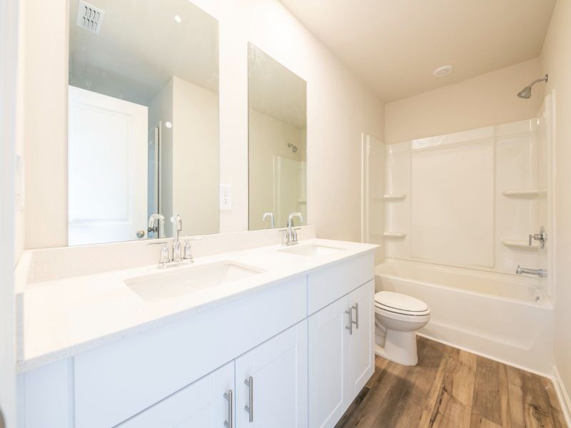 A dual entry bathroom connects the two secondary bedrooms.