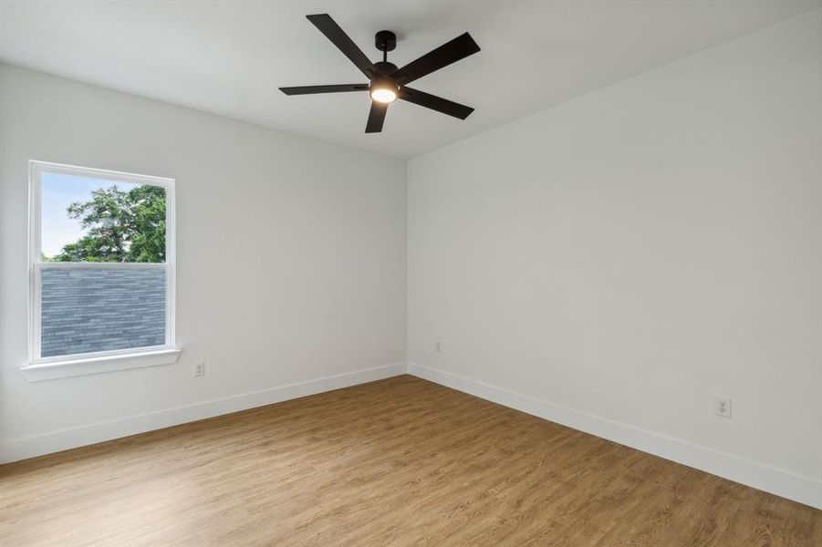 Empty room featuring ceiling fan and light wood-type flooring