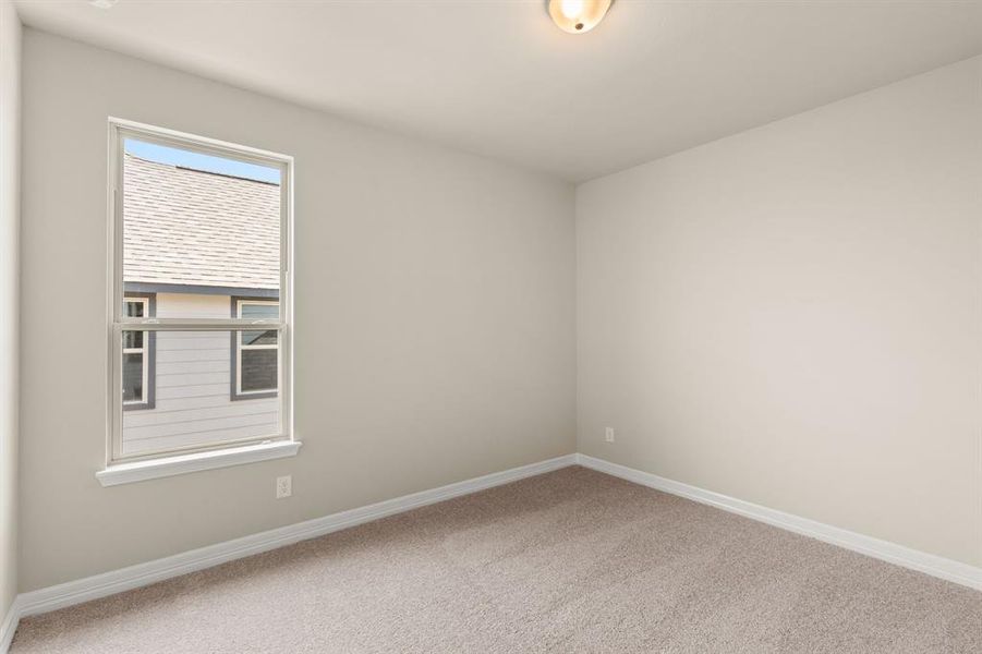 Your secondary bedroom features plush carpet, fresh paint, closet, and a large window that lets in plenty of natural lighting.