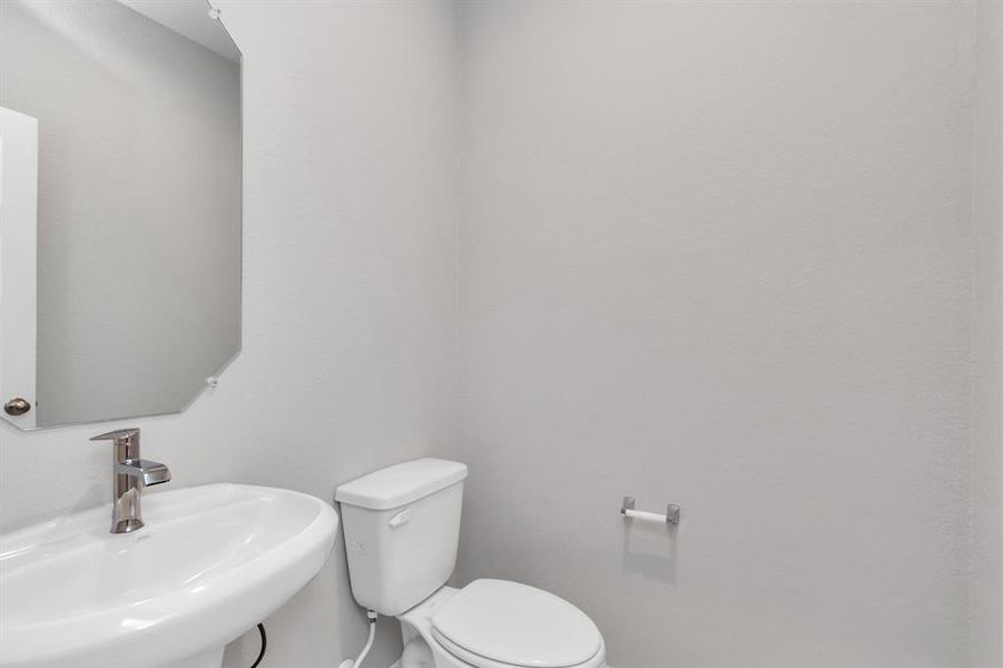 Half bath. Sample photo of completed home with similar floor plan. As-built interior colors and selections may vary