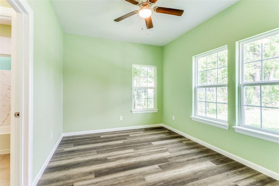 Spare room featuring wood-type flooring and ceiling fan