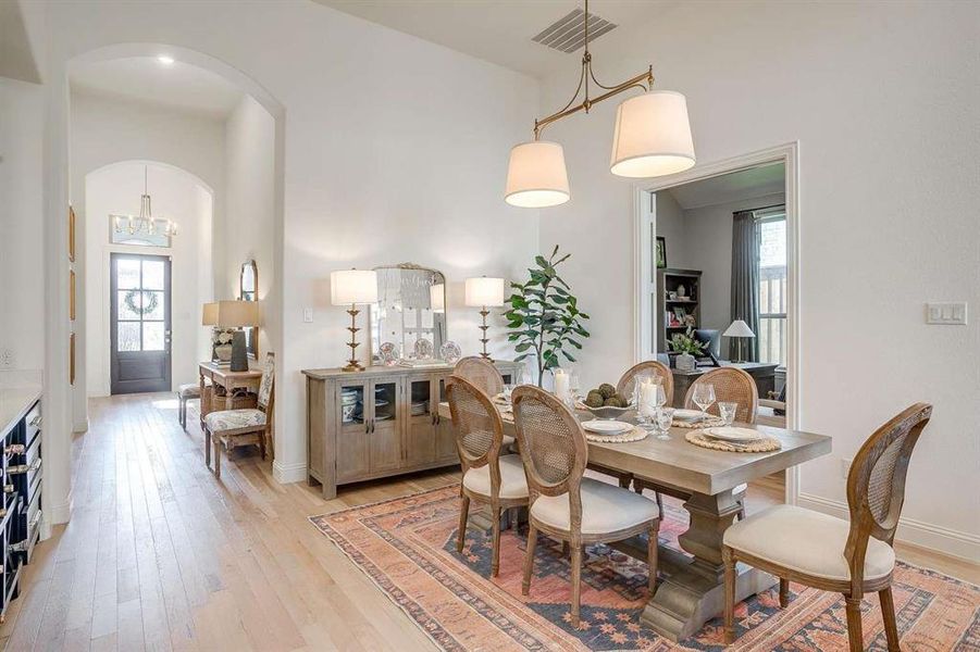 Dining room with a high ceiling and light wood-type flooring