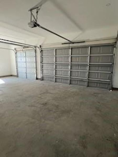 Garage featuring a garage door opener