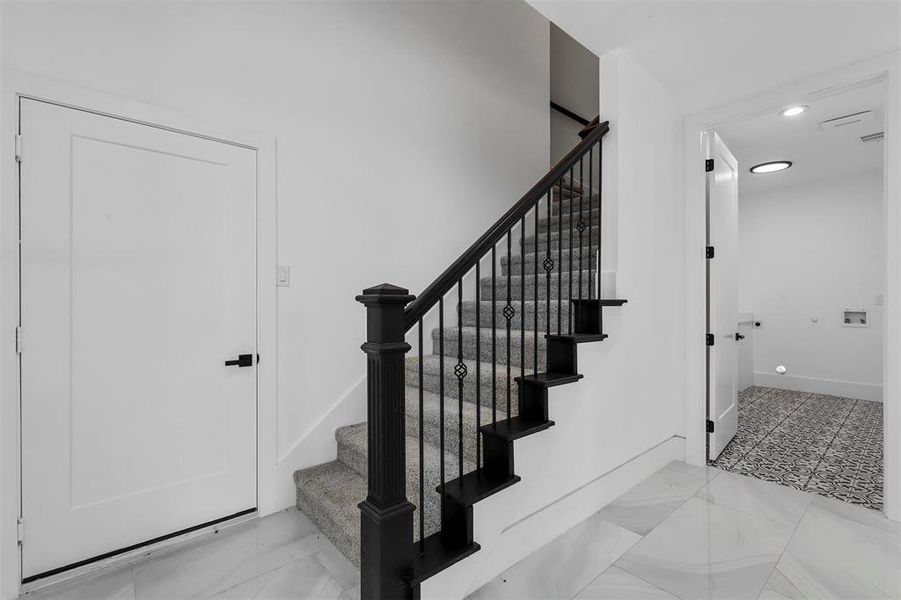 Stairs featuring light tile patterned floors