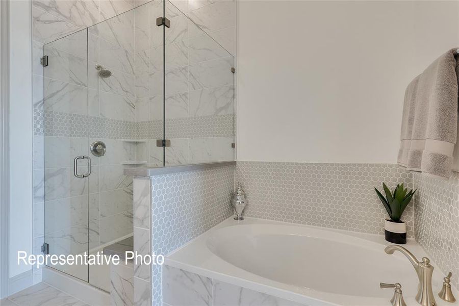 Bathroom featuring tile flooring and separate shower and tub