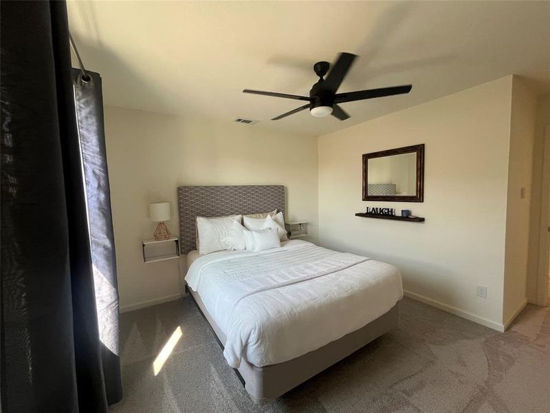 Bedroom featuring ceiling fan and carpet floors