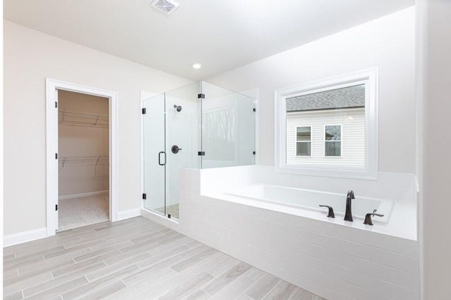 Relax after a day at the office is this large soaking tub.  Photo not actual home, but previously built Mansfield plan.