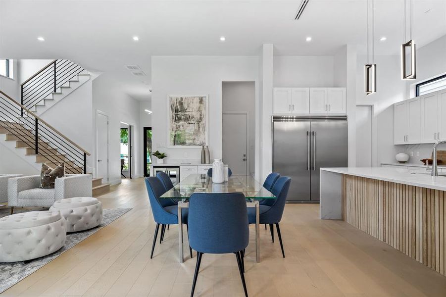 Dining room with sink and light wood-type flooring