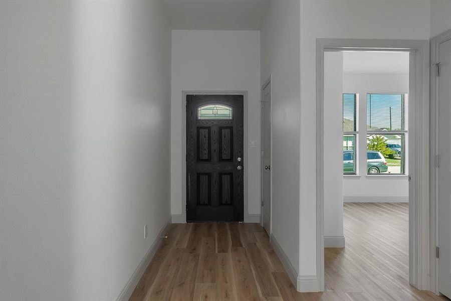 Doorway with light wood-type flooring