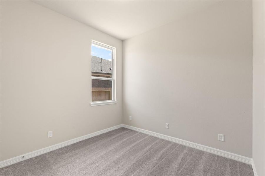 Your secondary bedroom features plush carpet, fresh paint, closet, and a large window that lets in plenty of natural lighting.