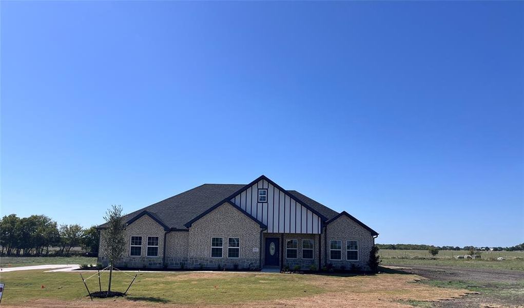 View of front of property with a front yard