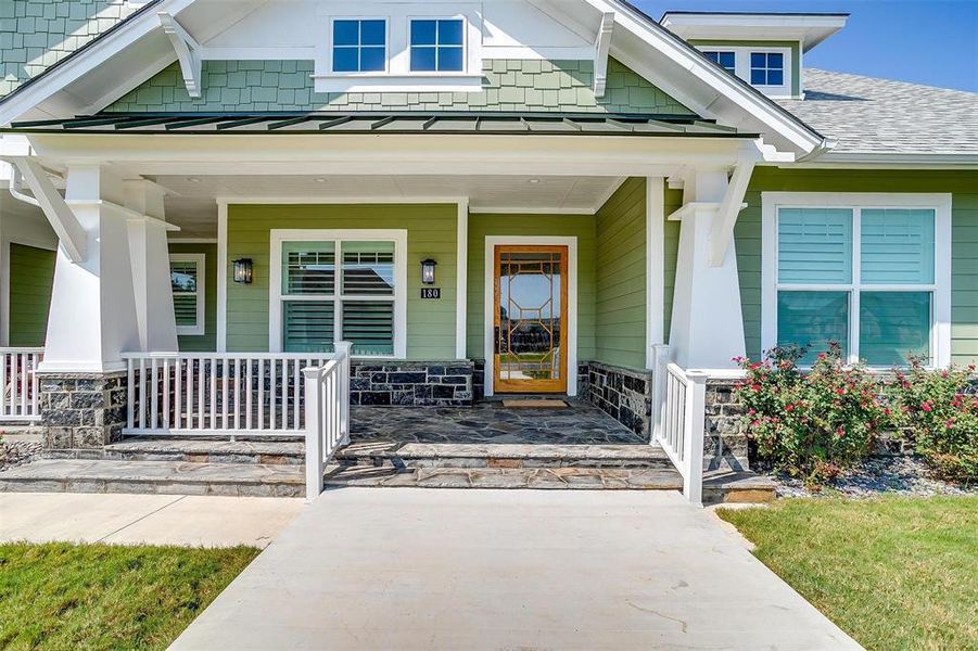 A grand front entrance featuring a beautifully crafted door invites you into this luxury home