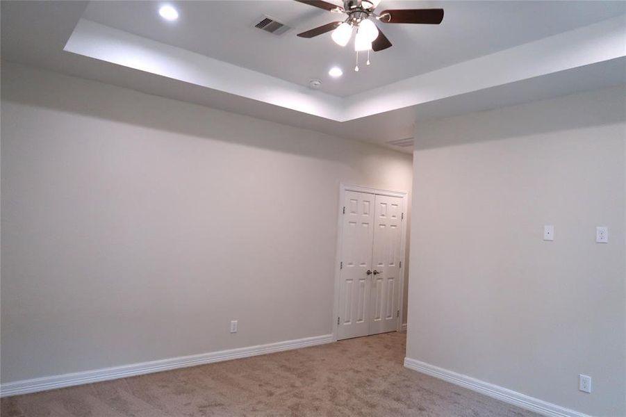 Large master bedroom with vaulted ceilings.