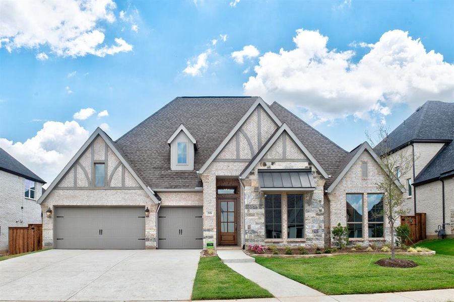 Tudor-style house with a garage and a front yard