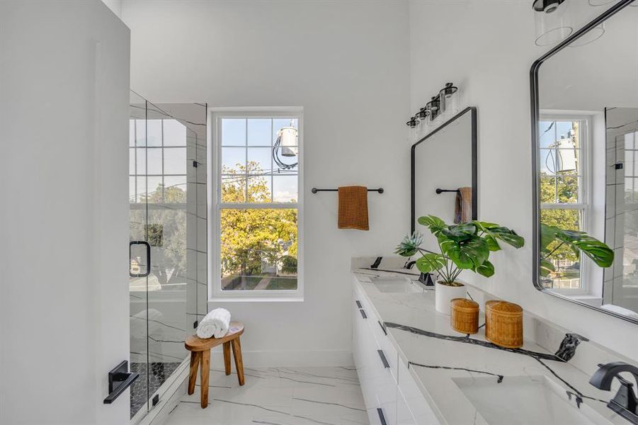 Bathroom featuring vanity and a shower with door