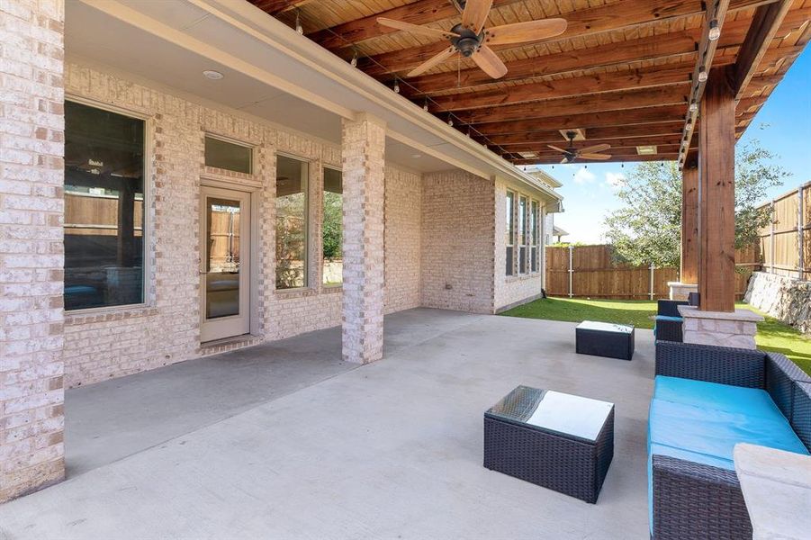 View of patio with ceiling fan and an outdoor living space