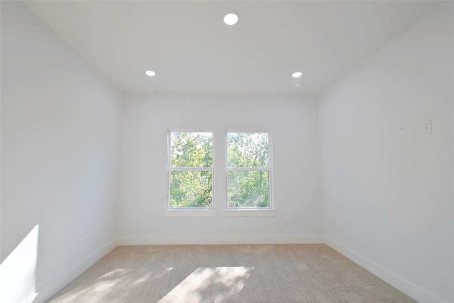 Empty room featuring light colored carpet