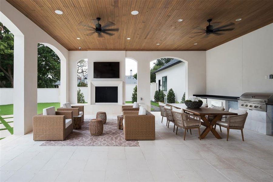 View of patio / terrace featuring area for grilling, an outdoor living space with a fireplace, and ceiling fan