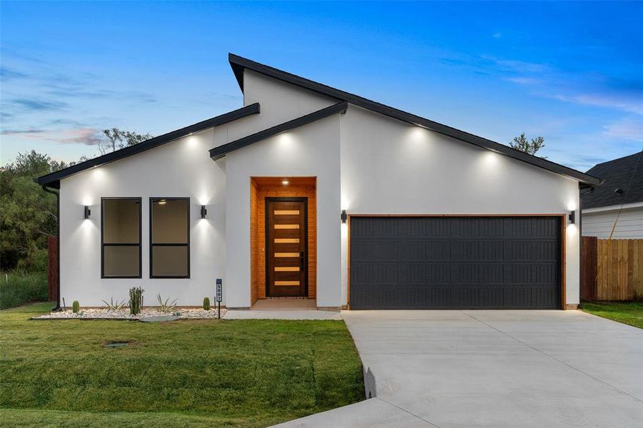 Modern home with a garage and a yard