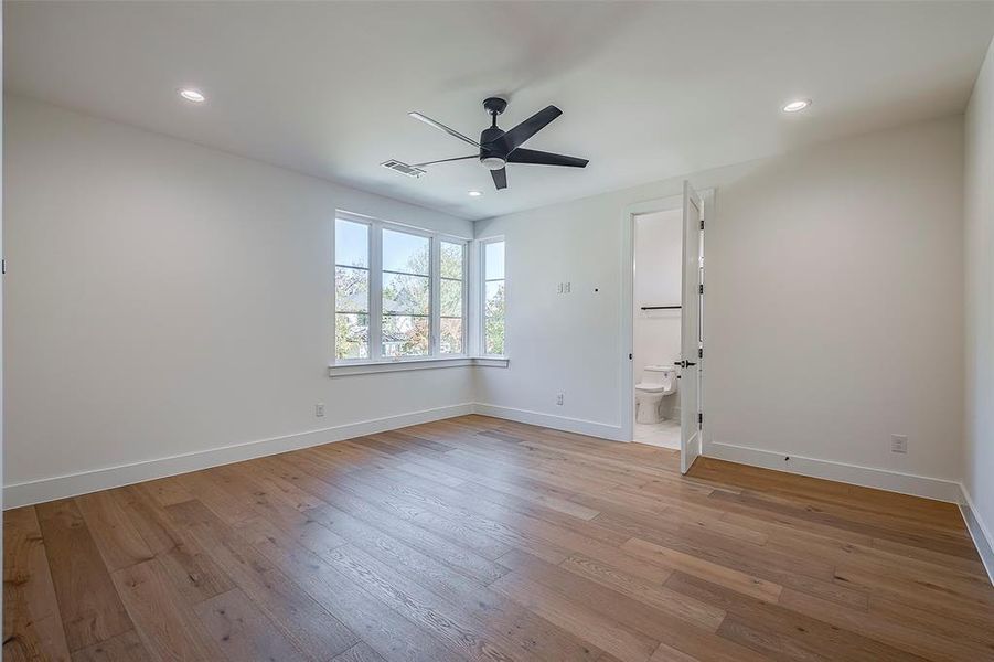 Unfurnished room featuring ceiling fan and light hardwood / wood-style floors