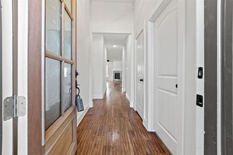 Hallway with dark hardwood / wood-style floors