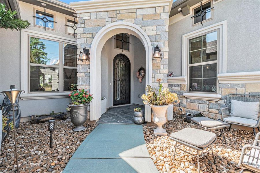 Step into sophistication with this chic foyer featuring striking exposed beams, leading seamlessly into an elegant dining area.