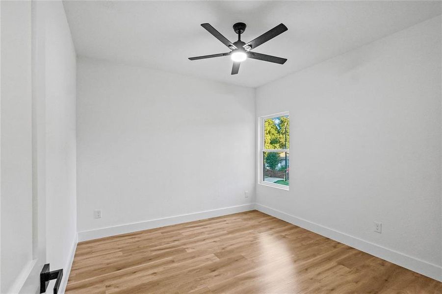 Empty room with light hardwood / wood-style flooring and ceiling fan