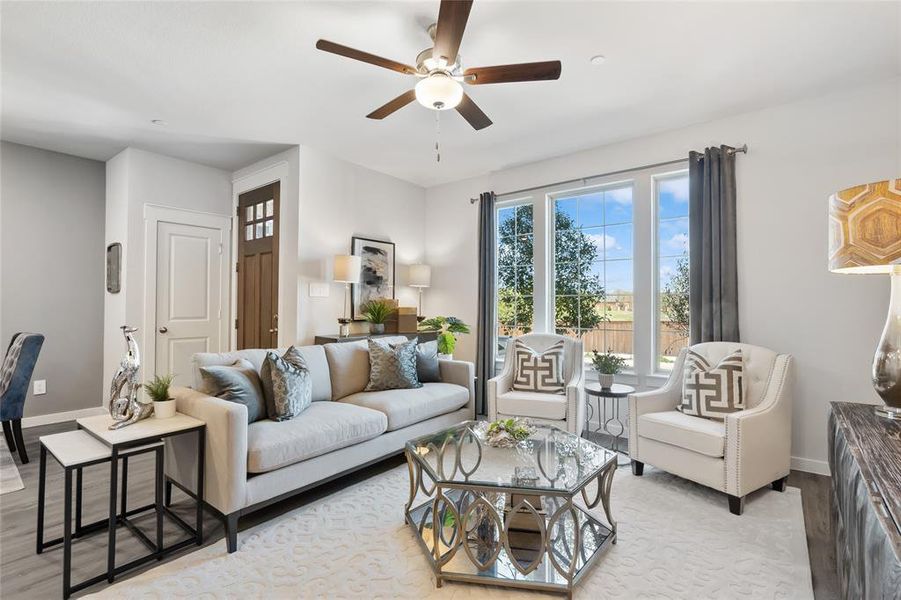 Living room featuring light hardwood / wood-style flooring and ceiling fan