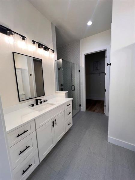 A bright white bathroom featuring a double sink and a large mirror above, creating a spacious and elegant atmosphere.