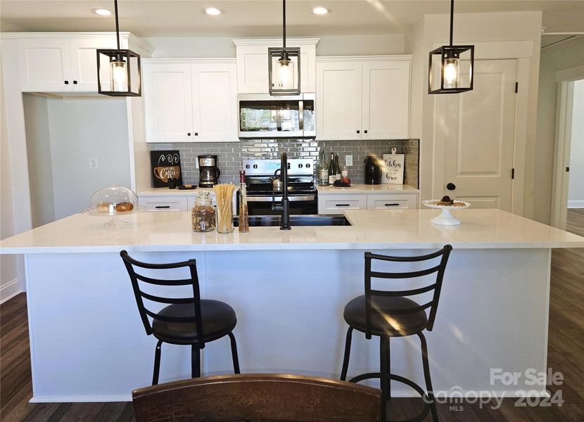 Dream Kitchen with 9 foot Quartz Island & Stainless appliances.