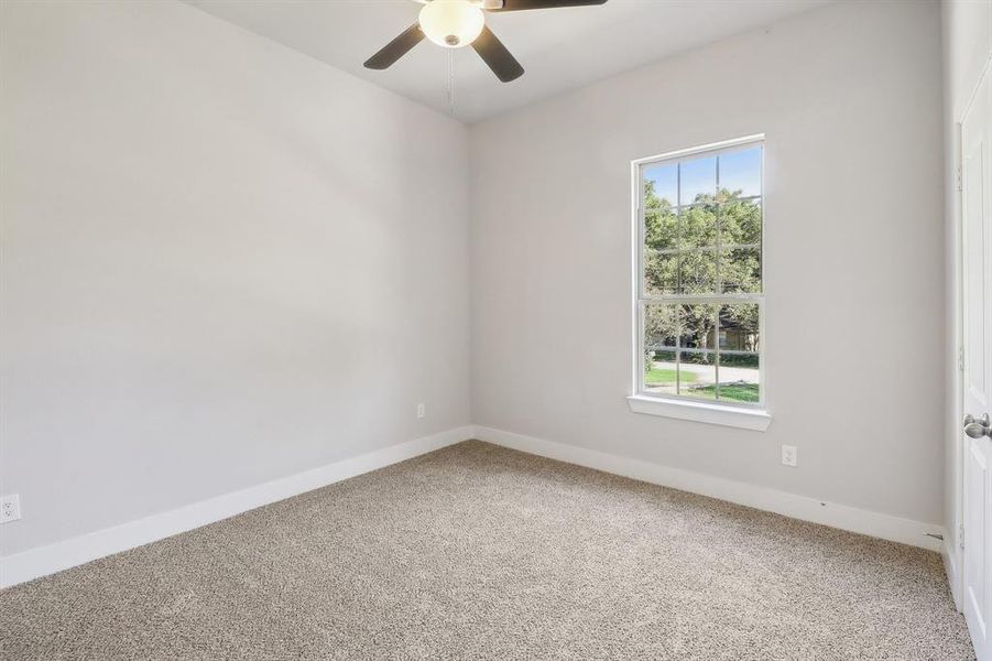 Unfurnished room with carpet and ceiling fan